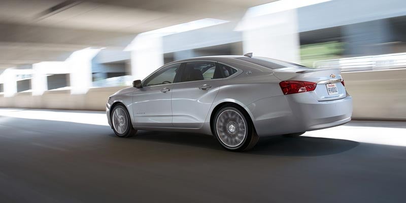 i.g. Burton Chevrolet of Berlin in Berlin MD birds eye view of an older Impala driving on a highway