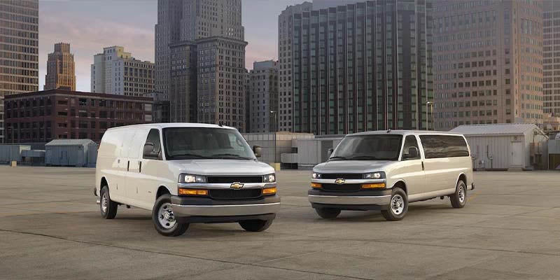 Chevrolet Express Van parked on the rooftop in the city seeing the beautiful sky
