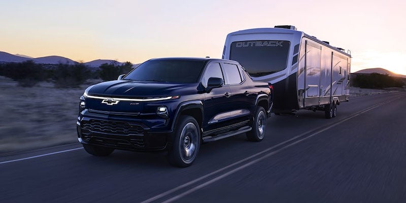 2024 Chevrolet Silverado 1500 EV towing a van