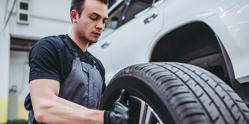 i.g. Burton Chevrolet of Berlin in Berlin MD technician changing a tire on a vehicle