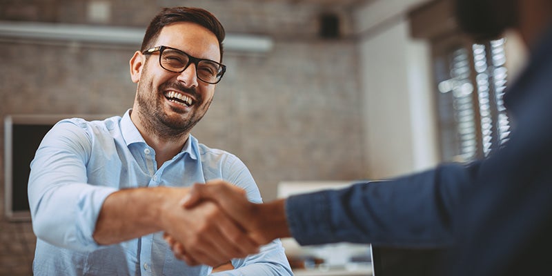i.g. Burton Chevrolet of Berlin in Berlin MD customer shaking hands with sales rep