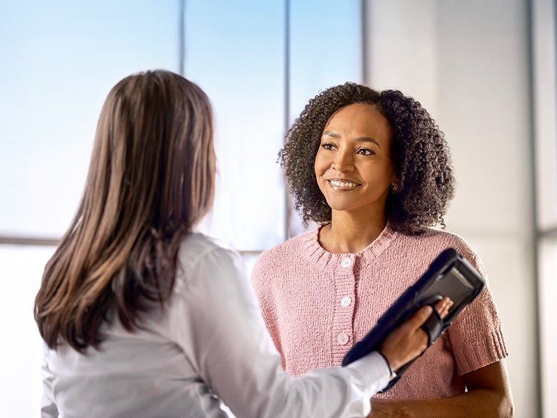 A photo of two people reviewing information on a tablet