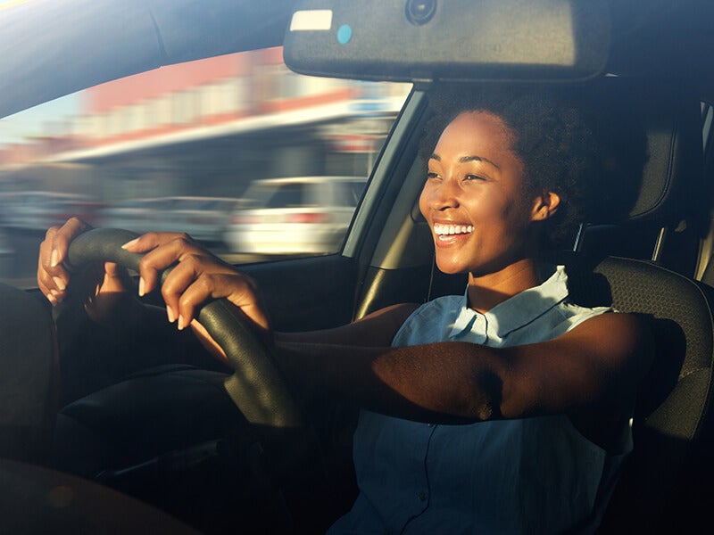 woman smiling as she goes to i.g. Burton Chevrolet of Berlin dealership to trade her Chevrolet vehicle