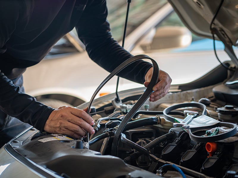 mechanic changing car belt at i.g. Burton Chevrolet of Berlin dealership